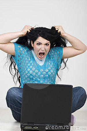 angry-woman-pulling-out-hair-in-front-of-laptop-thumb13951257.jpg